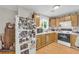 Functional kitchen featuring wood floors, natural tone cabinetry, stainless steel appliances, and plenty of storage space at 483 Glen Terrace Rd, Auburn, GA 30011