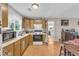 Bright kitchen with wood floors, natural-tone cabinetry, plenty of counter space, and connecting living space at 483 Glen Terrace Rd, Auburn, GA 30011