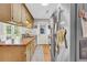 Charming kitchen featuring wood counters, cabinets, stainless steel fridge, and access to backyard through French doors at 483 Glen Terrace Rd, Auburn, GA 30011