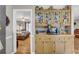 Charming kitchen with wooden cabinetry, photo display case, wood floors, microwave, and access to a cozy bedroom at 483 Glen Terrace Rd, Auburn, GA 30011