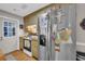 Kitchen features wood counters, cabinets, stainless steel refrigerator, electric range, and access to side yard at 483 Glen Terrace Rd, Auburn, GA 30011