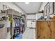 Large laundry room with clothing racks, cabinets, washer, dryer, tile floor, and wooden storage chest at 483 Glen Terrace Rd, Auburn, GA 30011
