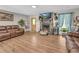 Open living room features a stone fireplace, vinyl floors, and a seamless transition into the kitchen at 483 Glen Terrace Rd, Auburn, GA 30011