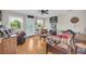 Cozy living room featuring wood floors, ceiling fan, and front door access at 483 Glen Terrace Rd, Auburn, GA 30011
