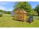 Wooden shed with a red roof, providing outdoor storage space on a well-maintained lawn at 483 Glen Terrace Rd, Auburn, GA 30011