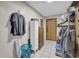 Utility room with a tile floor, shelving, clothing racks, storage cabinets and exterior door at 483 Glen Terrace Rd, Auburn, GA 30011