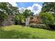 Lush backyard featuring a two-story deck and steps, surrounded by mature trees and greenery at 1972 Wingate Rd, Chamblee, GA 30341