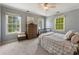 Sun-filled bedroom features neutral colors, a ceiling fan, and three windows allowing for an abundance of natural light at 1972 Wingate Rd, Chamblee, GA 30341