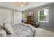 A bedroom featuring soft colors, two closets, a ceiling fan, and a pair of windows at 1972 Wingate Rd, Chamblee, GA 30341
