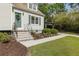 Welcoming home exterior featuring a well-kept lawn, landscaped garden beds, and a charming covered carport at 1972 Wingate Rd, Chamblee, GA 30341