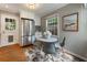 Bright kitchen and dining area features a stainless steel refrigerator, white cabinets, and modern appliances at 1972 Wingate Rd, Chamblee, GA 30341
