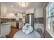 Bright kitchen with white cabinets, stainless steel refrigerator, and a view of the backyard at 1972 Wingate Rd, Chamblee, GA 30341