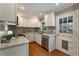 Stylish kitchen featuring white cabinets, stainless steel appliances, and a backdoor entrance to the backyard at 1972 Wingate Rd, Chamblee, GA 30341