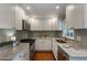 Bright kitchen featuring white cabinets, stainless steel appliances, and marble countertops at 1972 Wingate Rd, Chamblee, GA 30341