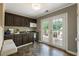 Modern kitchenette featuring dark cabinets, a wine fridge, ample counter space, and direct access to an outdoor deck at 1972 Wingate Rd, Chamblee, GA 30341