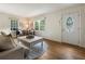 Inviting living room featuring hardwood floors, large windows, a comfy sofa, and an elegant coffee table at 1972 Wingate Rd, Chamblee, GA 30341