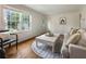 Comfortable living room featuring hardwood floors, bright windows, a cozy sofa, and stylish accent pieces at 1972 Wingate Rd, Chamblee, GA 30341