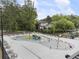 Community splash pad and picnic tables surrounded by mature trees and other community spaces at 1972 Wingate Rd, Chamblee, GA 30341