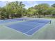 Community tennis courts ready for play with green surfaces, netting, and surrounding trees at 1972 Wingate Rd, Chamblee, GA 30341