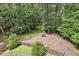 View of fenced backyard with mature trees and natural landscape, offering privacy at 200 River Pass Trl, Atlanta, GA 30350