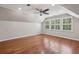 Attic bedroom featuring hardwood floors, windows, ceiling fan, and white walls at 200 River Pass Trl, Atlanta, GA 30350