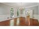 Formal dining room with hardwood floors, decorative trim, and views into the kitchen at 200 River Pass Trl, Atlanta, GA 30350