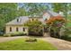 Charming two-story traditional home with a circular driveway and lush, mature landscaping at 200 River Pass Trl, Atlanta, GA 30350