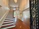 Grand foyer with soaring ceilings, hardwood floors, and an elegant staircase at 200 River Pass Trl, Atlanta, GA 30350