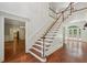 Bright foyer showcasing hardwood floors, staircase, and entryways to adjacent rooms at 200 River Pass Trl, Atlanta, GA 30350