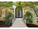Elegant entryway featuring a wrought iron double door and stone steps at 200 River Pass Trl, Atlanta, GA 30350
