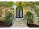 Close-up of the main entry featuring detailed iron double doors and stone steps at 200 River Pass Trl, Atlanta, GA 30350