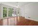 Large living room with beautiful hardwood floors, windows, and view of the outdoors at 200 River Pass Trl, Atlanta, GA 30350