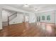 Living room with hardwood floors, staircase, white walls, and views of the outside at 200 River Pass Trl, Atlanta, GA 30350