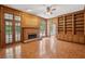 Cozy living room featuring hardwood floors, fireplace, built-in bookshelves, and french doors at 200 River Pass Trl, Atlanta, GA 30350