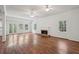 Living room with hardwood floors, fireplace, white walls, and views of the outside at 200 River Pass Trl, Atlanta, GA 30350