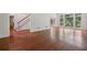 Spacious living room with gleaming hardwood floors and large windows with backyard views at 200 River Pass Trl, Atlanta, GA 30350