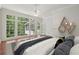 Bright primary bedroom with hardwood floors, large windows, and views of the backyard at 200 River Pass Trl, Atlanta, GA 30350