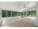 Bright sunroom with multiple windows and a ceiling fan, leading to an outdoor deck area at 200 River Pass Trl, Atlanta, GA 30350