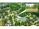 Aerial view of community with swimming pool, tennis courts and lush landscaping at 2222 Haventree Ct, Lawrenceville, GA 30043