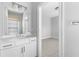 Bathroom with white vanity and a window looking into an adjacent room at 2222 Haventree Ct, Lawrenceville, GA 30043