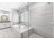 Bright bathroom features a soaking tub, glass enclosed shower, and white vanity with ample counter space at 2222 Haventree Ct, Lawrenceville, GA 30043