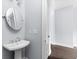 Cozy half bathroom featuring a pedestal sink and stylish fixtures at 2222 Haventree Ct, Lawrenceville, GA 30043