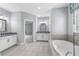 Bathroom features dual sinks, tile floors, and a soaking tub at 2222 Haventree Ct, Lawrenceville, GA 30043