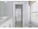 Bright bathroom has a white vanity, tile floors, and large window for natural light at 2222 Haventree Ct, Lawrenceville, GA 30043