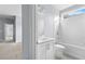 Bright bathroom features white vanity, toilet, subway tile and large window at 2222 Haventree Ct, Lawrenceville, GA 30043