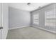 The bedroom has two windows and is carpeted at 2222 Haventree Ct, Lawrenceville, GA 30043