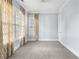 Bright bedroom with soft carpet, neutral walls, and light-filtering curtains at 2222 Haventree Ct, Lawrenceville, GA 30043