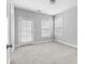 Well-lit bedroom features neutral carpeting, a door to the outside, and a standard closet at 2222 Haventree Ct, Lawrenceville, GA 30043