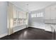 Bright dining area with large windows, stylish curtains and dark hardwood flooring at 2222 Haventree Ct, Lawrenceville, GA 30043