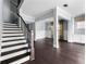 Grand entryway with staircase, hardwood floors, and elegant wainscoting leading to the living areas at 2222 Haventree Ct, Lawrenceville, GA 30043